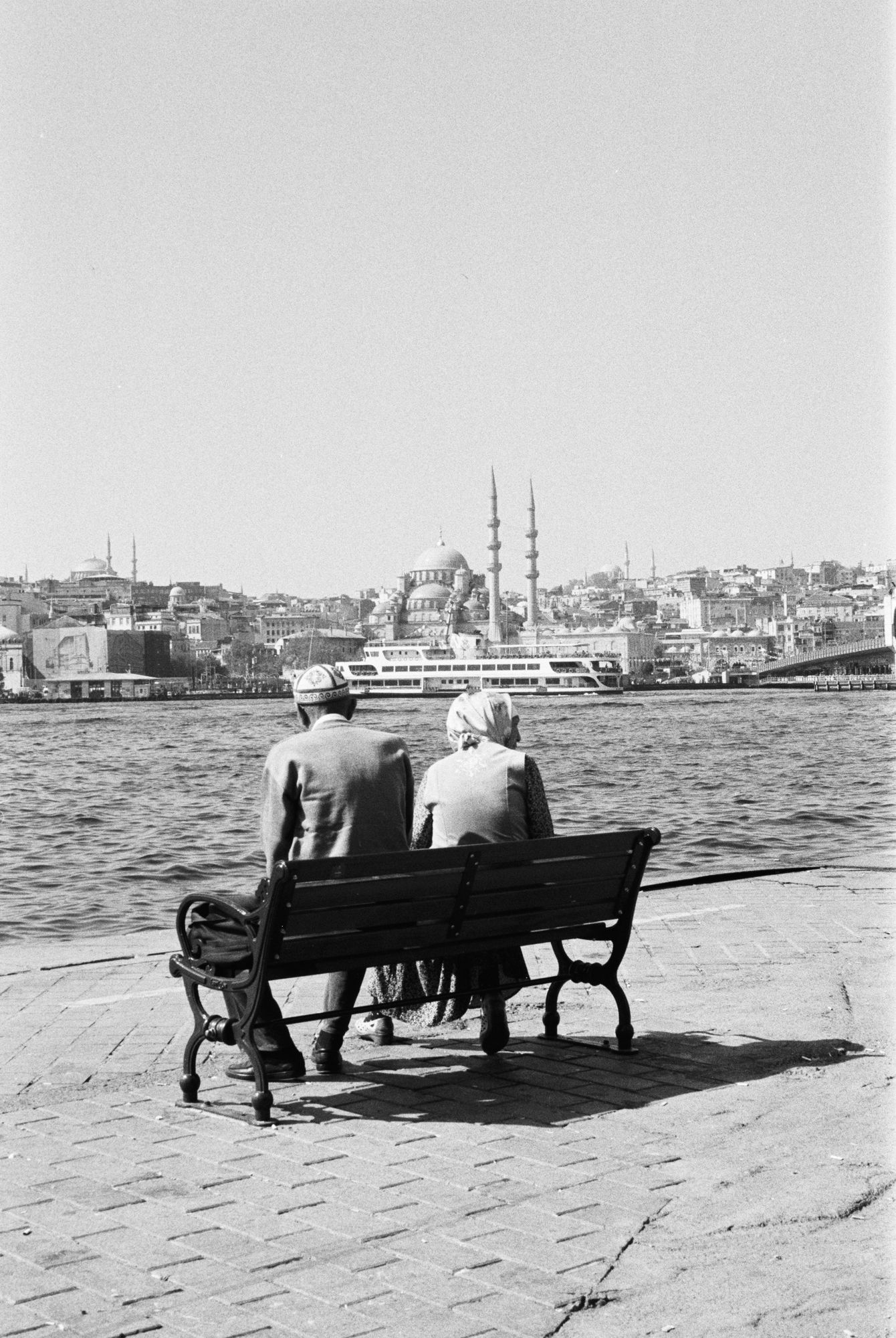 Elderly couple on bench overlooking Istanbul mosques