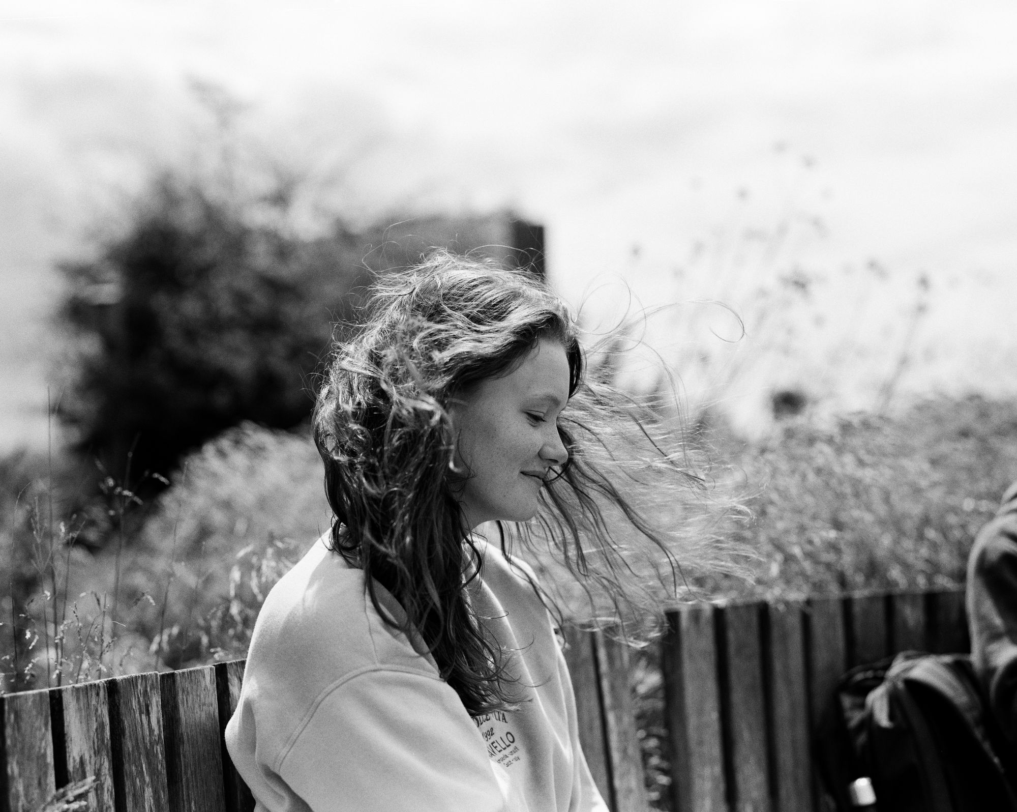 Young woman with wind in her hair, candid